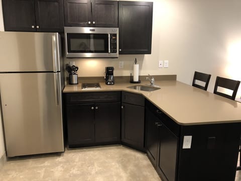 King One-Bedroom Suite | Private kitchenette | Full-size fridge, microwave, stovetop, coffee/tea maker