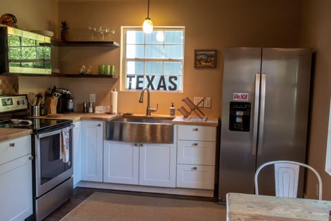 Open floorpan kitchen and dining area. Coffee maker & electric hot water boiler