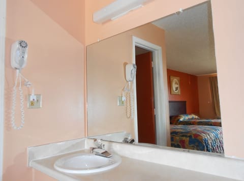 Bathtub, rainfall showerhead, hair dryer, towels