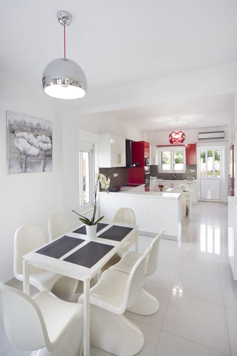 One of the dining tables and the kitchenette in the background