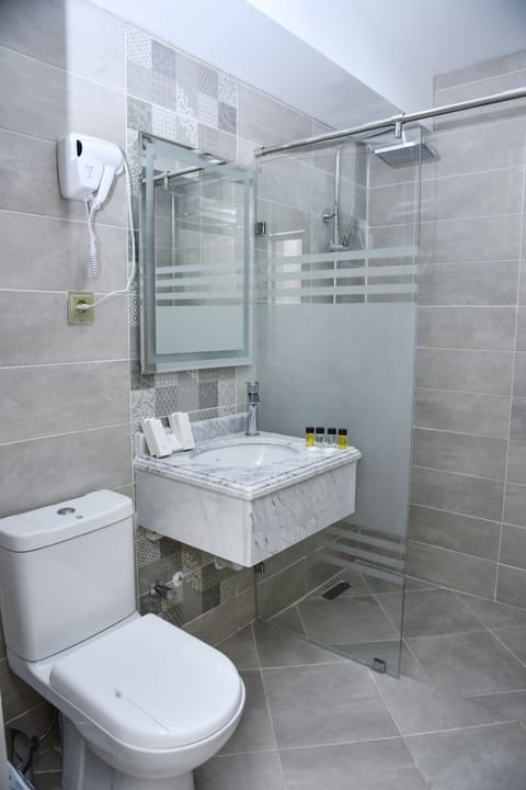 Deluxe Room, 1 Bedroom | Bathroom | Shower, hair dryer, slippers, towels