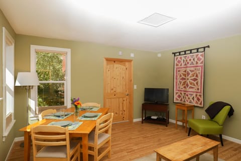 Living and dining area. Door to gear storage area.