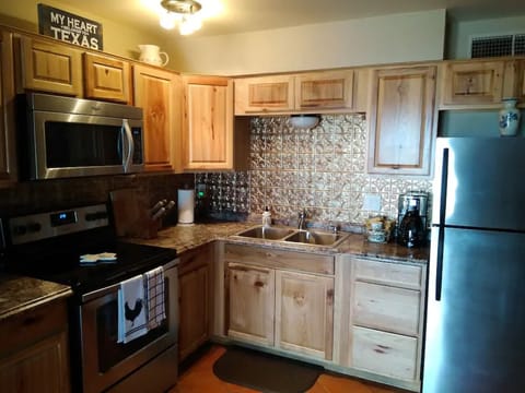 Full-size coffee maker, coffee, creamer, and sweeteners available for guests.