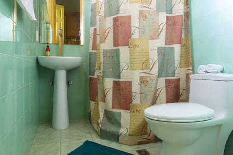 Family Triple Room, Garden View | Bathroom | Rainfall showerhead, hair dryer, towels, soap