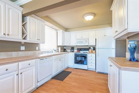 Upper Surf view kitchen has a dishwasher, microwave, blender, crockpot,12 cup coffee maker and cook/dinnerware