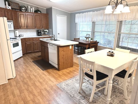 The kitchen has lots of windows and overlooks the backyard with a great view.