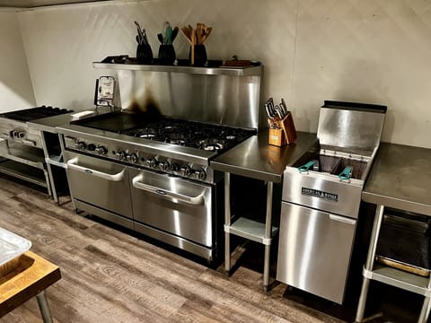Commercial kitchen. Gas range with two ovens, 6 burners, and 24" griddle