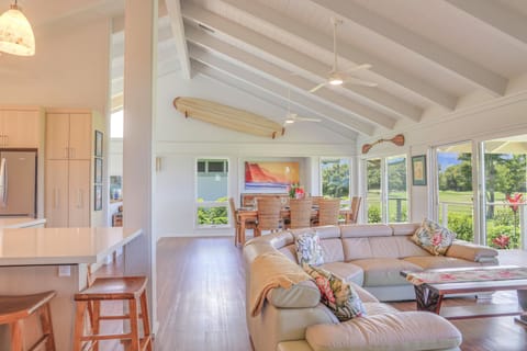 Upstairs living room looking toward dining area and kitchen on left