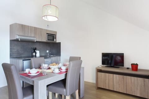 Prepare meals in the kitchenette and enjoy them at the dining table.