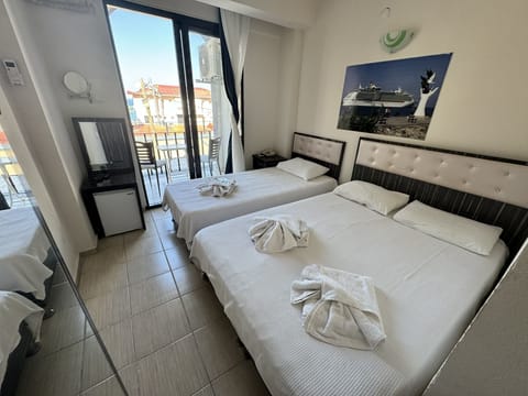 Standard Triple Room, Partial Sea View | Minibar, iron/ironing board, free WiFi, bed sheets