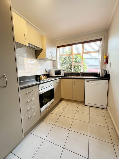 Large One Bedroom Suite | Private kitchen | Full-size fridge, microwave, oven, stovetop