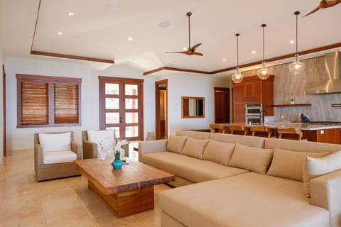 Unwind in the open-concept living space featuring soaring ceilings and plush, stylish seating.