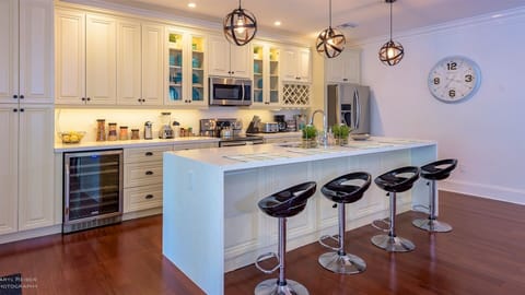 The fully-equipped kitchen is open to the living room and features brand new Samsung appliances...