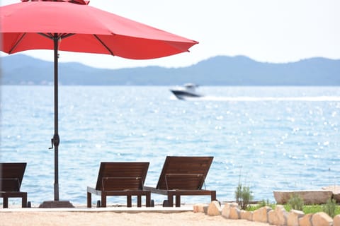 Private beach, white sand, sun loungers, beach umbrellas