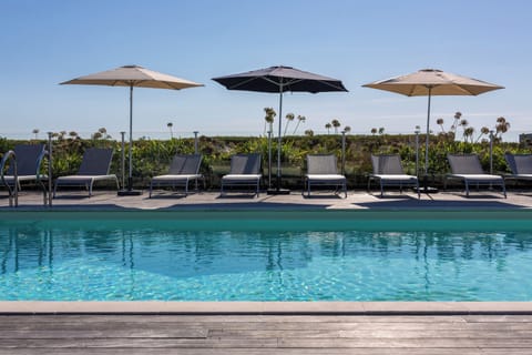 Seasonal outdoor pool, open 9 AM to 9 PM, pool umbrellas, sun loungers