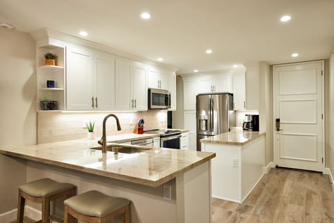 The delightful Chef's Kitchen is equipped with dishes, pots and pans, and cooking utensils.