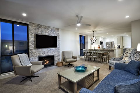 The living area features a cozy ledgestone fireplace.