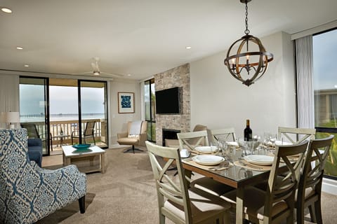The dining and living areas of Coastal Cottage look down the beach to the Oceanside Pier.