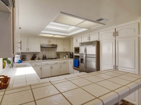 Kitchen has gas stove with hood, Oven, Microwave, Fridge/Freezer, large pantry