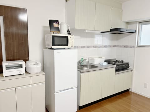 Family Condo, Multiple Beds | Private kitchen | Fridge, microwave, stovetop, electric kettle