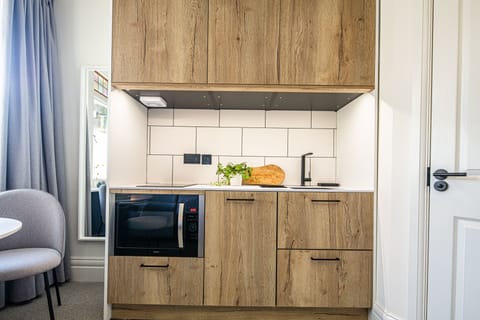 Deluxe Studio, Kitchenette, Ground Floor | Private kitchen | Fridge, espresso maker, coffee/tea maker, electric kettle