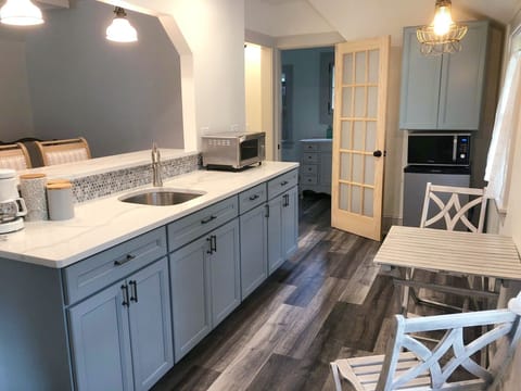 The kitchen has a microwave, convection oven, hotplate, fridge, pots & utensils