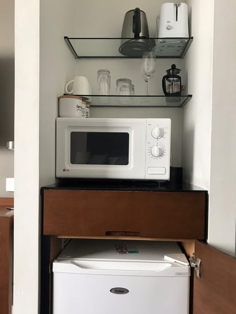 Mini-fridge, microwave, electric kettle, cookware/dishes/utensils