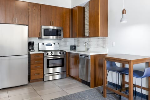 Suite, 1 King Bed with Sofa bed, Non Smoking | Private kitchen | Full-size fridge, microwave, stovetop, dishwasher