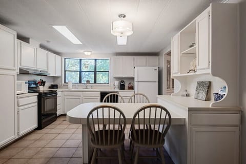 This kitchen features all of your essentials and has additional seating