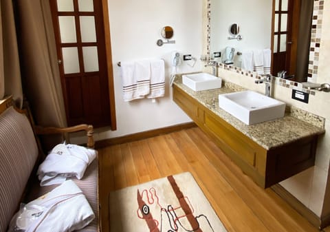 Deluxe Studio Suite | Bathroom | Designer toiletries, hair dryer, bathrobes, slippers