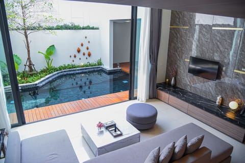 Grande Pool Villa 3 Bedroom | Living area | 49-inch LED TV with cable channels, TV, books