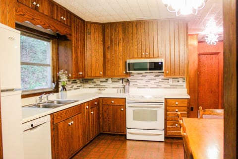 Kitchen with updated tile and appliances.