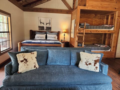 Open floor plan with king bed and bunk beds