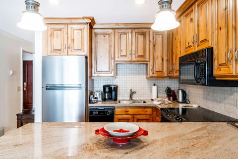 1-Bedroom Condominium #24 | Private kitchen | Full-size fridge, microwave, stovetop, dishwasher