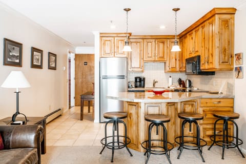 1-Bedroom Condominium #24 | Private kitchen | Full-size fridge, microwave, stovetop, dishwasher