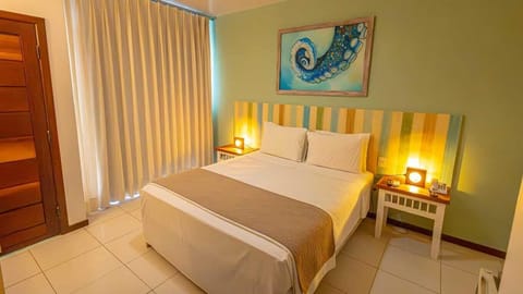 Deluxe Room, Sea View | Minibar, in-room safe, desk, blackout drapes