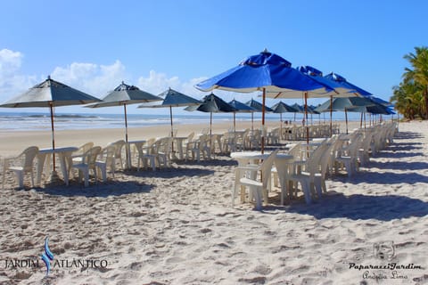 On the beach, white sand, sun loungers, beach umbrellas