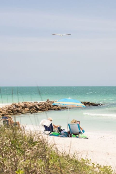 On the beach, white sand, beach umbrellas, beach towels