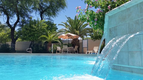Tropical pool and Spa area with community grills.