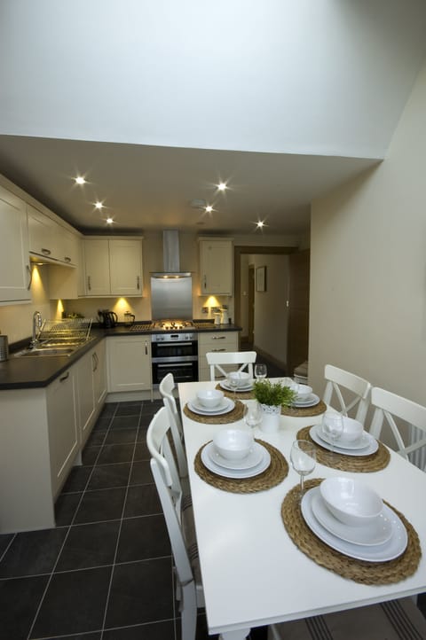 Fully fitted kitchen  with dining table leading off to sun-room