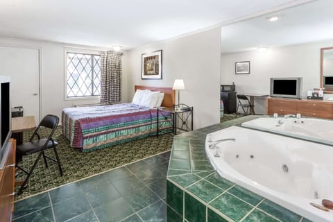 Suite, 1 King Bed, Jetted Tub | Desk, iron/ironing board, cribs/infant beds, rollaway beds