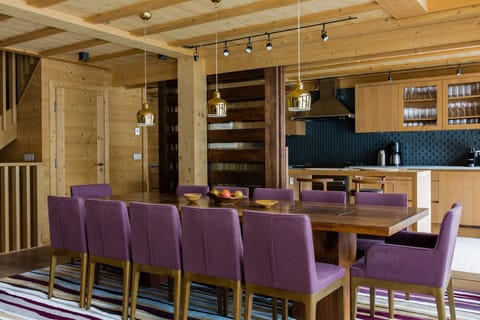 Dining table seating 12 and sliding divider to kitchen