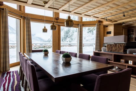 Dining table positioned in front of glass doors onto terrace