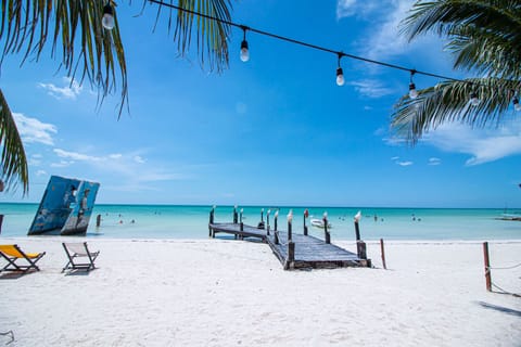 On the beach, white sand, sun loungers, beach towels