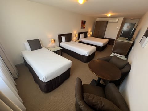 Deluxe Queen with Two Singles | Minibar, in-room safe, iron/ironing board, free WiFi
