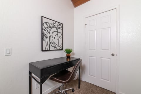 Upstairs 5th bedroom with office desk and chair.