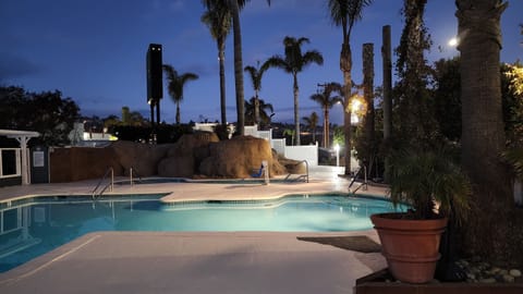 Outdoor pool, a heated pool, open 10:00 AM to 10:00 PM, pool umbrellas