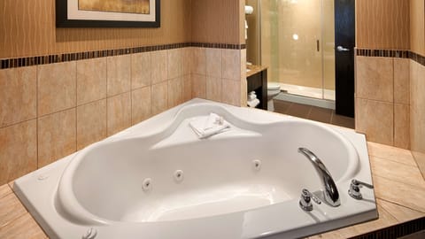 Suite, 1 King Bed, Non Smoking, Jetted Tub | Bathroom | Combined shower/tub, rainfall showerhead, designer toiletries