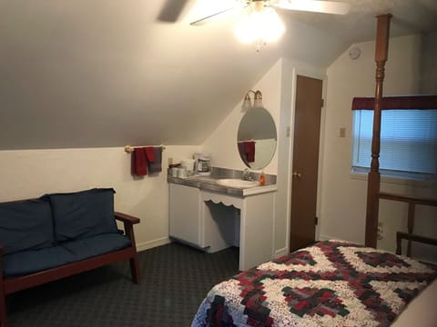 Upstairs has a sink and vanity as well as a small sitting area.