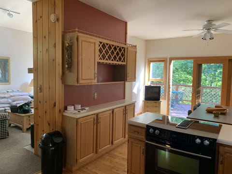 Kitchen with view to dining area and deck beyond and partial view of living room